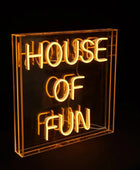 Neon sign with 'HOUSE OF FUN' text on a black background
