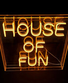 Neon sign with 'House of Fun' text inside a clear acrylic box on a black background