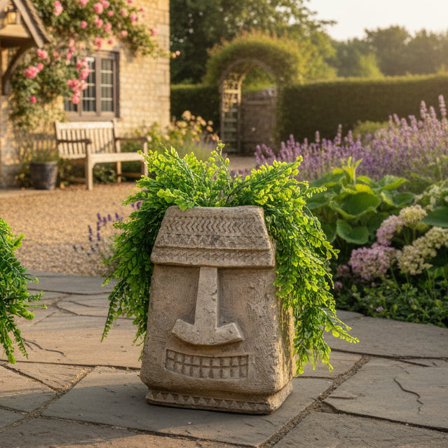 Decorative stone totem with greenery against a brick wall