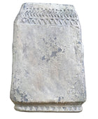 Decorative stone block with textured surface on a wooden surface
