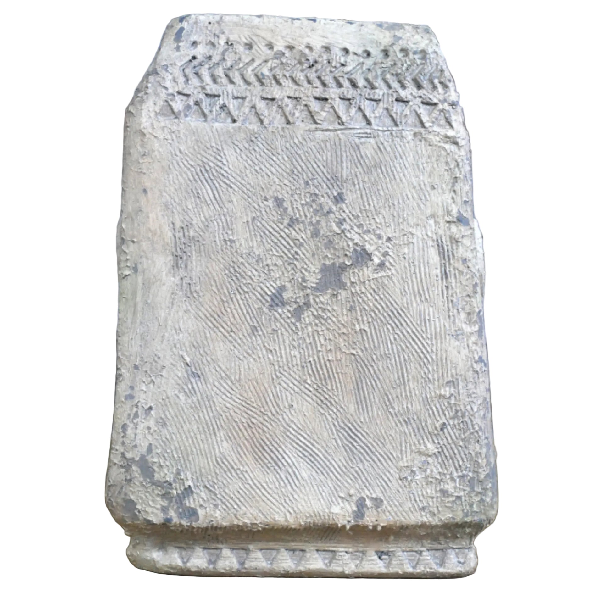 Decorative stone block with textured surface on a wooden surface