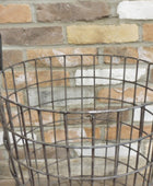 Wire basket against a brick wall