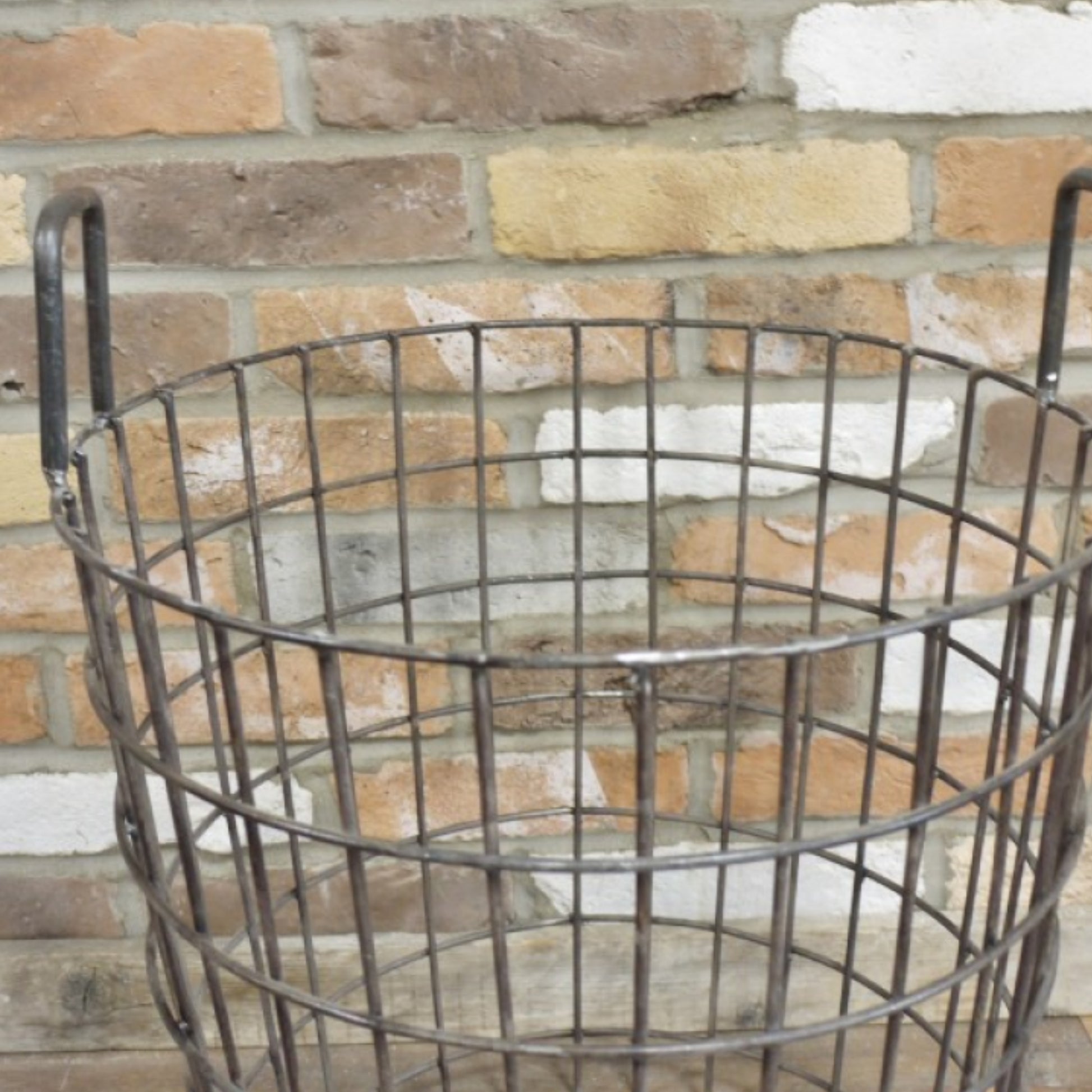 Wire basket against a brick wall