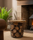 Cozy living room with a fireplace, wooden log holder, and fern.