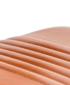 Close-up of a curved, ribbed leather surface in a warm tan or cognac brown color against a white background.