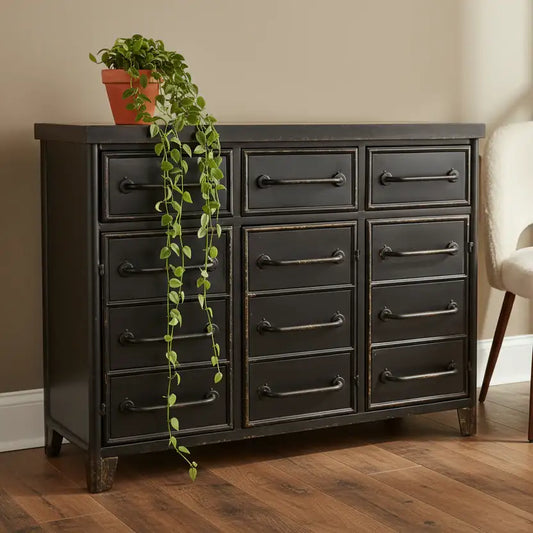 Dark wooden dresser with multiple drawers on a wooden floor, featuring a potted plant on top.