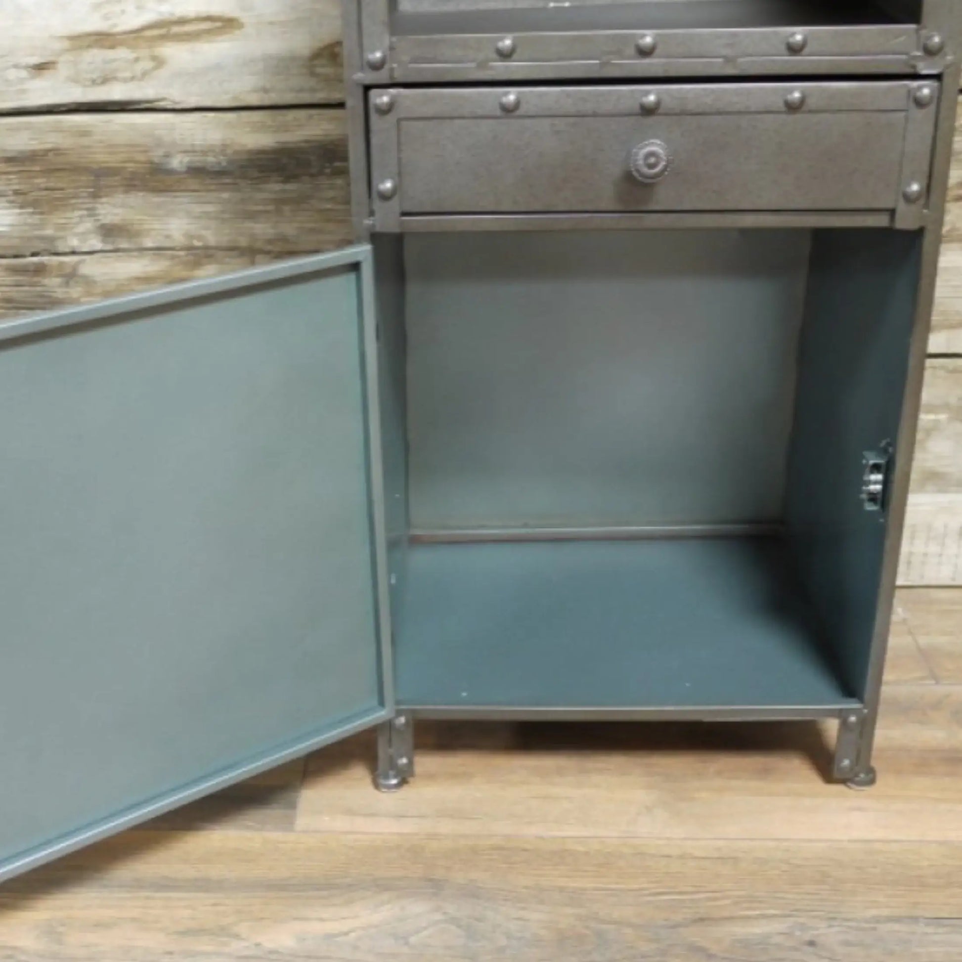 Metal cabinet with open door on a wooden floor