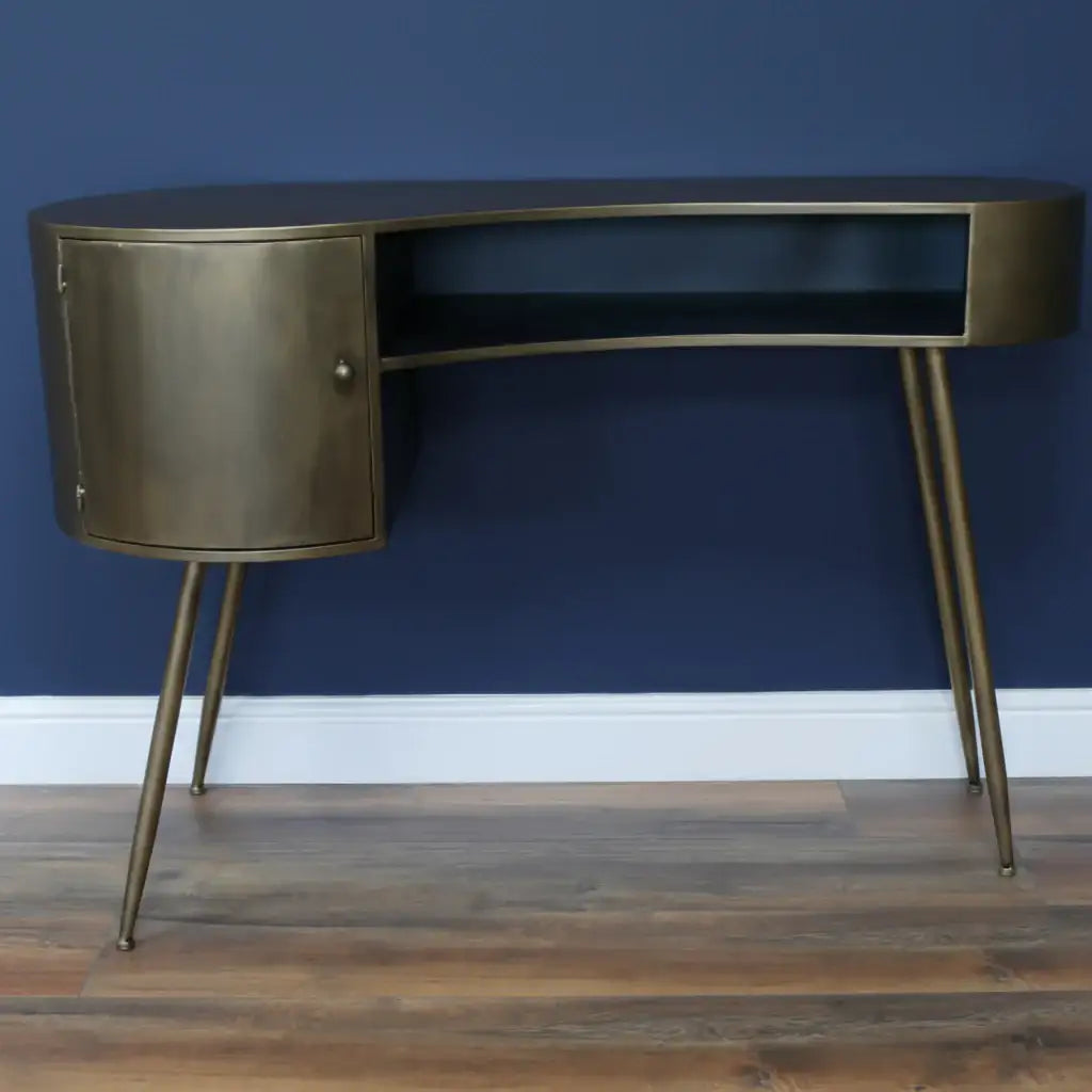 Bronze desk with a black shelf against a gray wall.