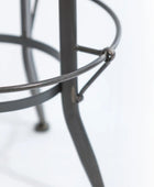 Close-up of a metal stool with a blurred background