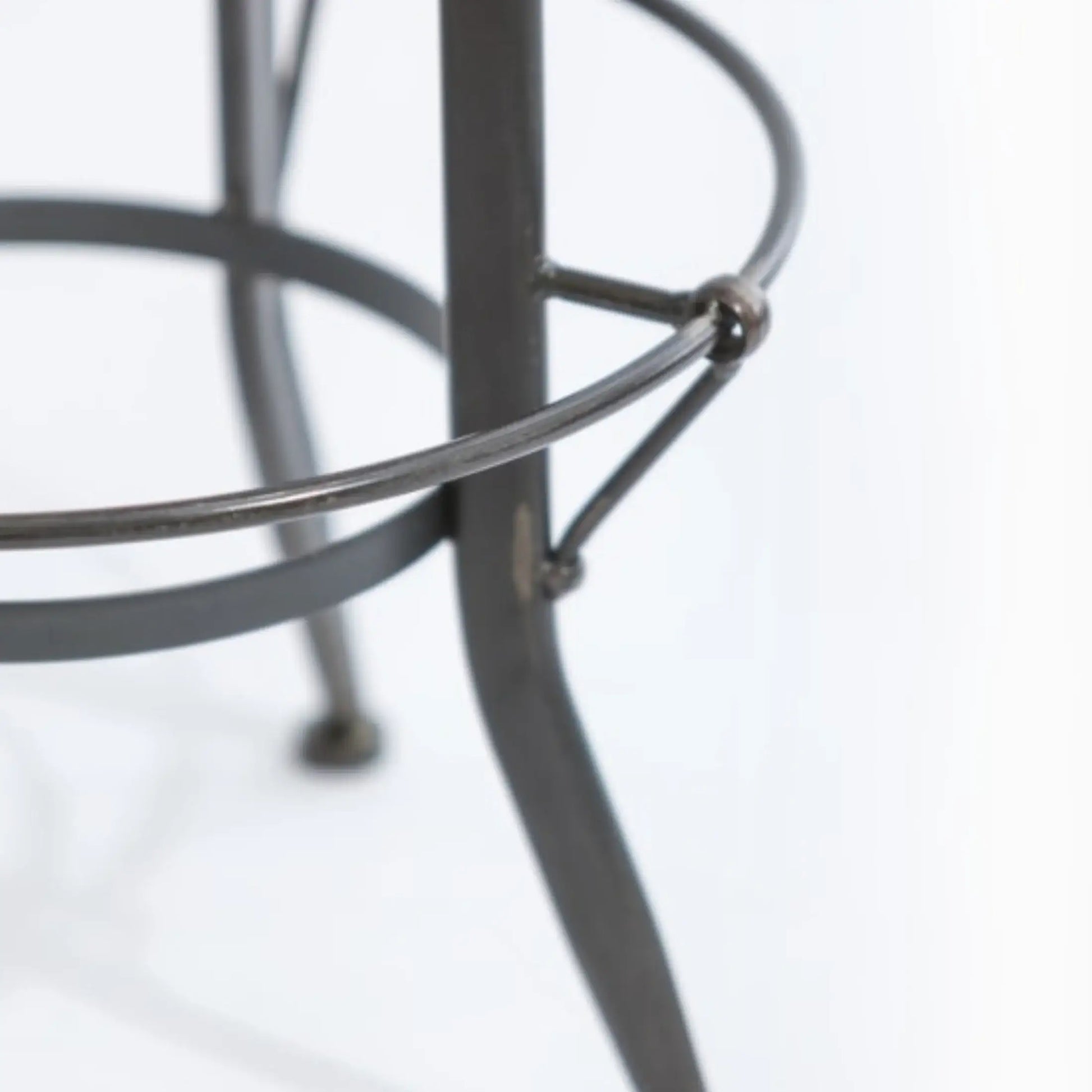 Close-up of a metal stool with a blurred background