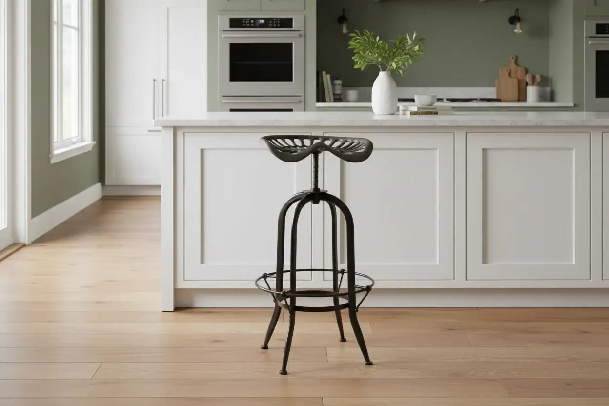 Black metal stool in a modern kitchen with white cabinets and wooden floor.