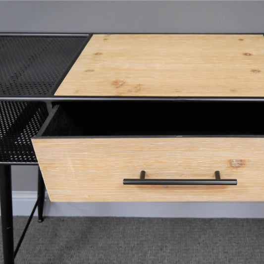 Wooden desk with a black metal frame and drawer handle, on a gray floor.