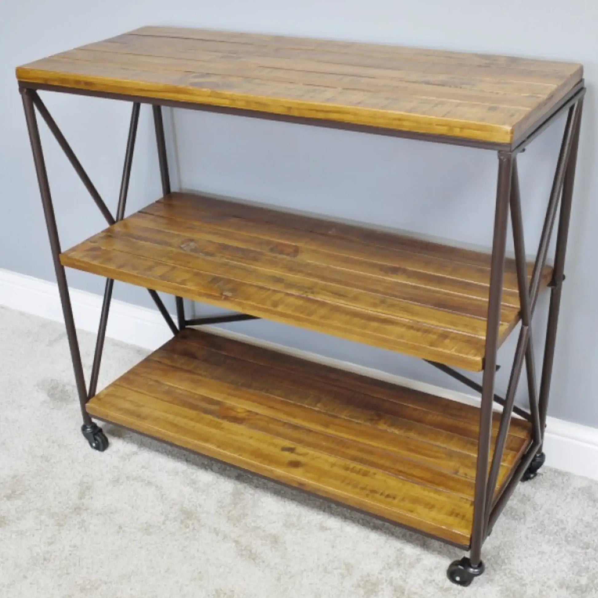 Wooden shelf with metal frame and wheels against a light gray wall.
