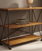 Wooden shelf with metal legs against a wall, featuring books and a globe.