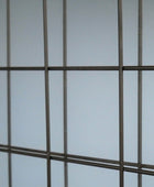 Metal grid against a light blue background