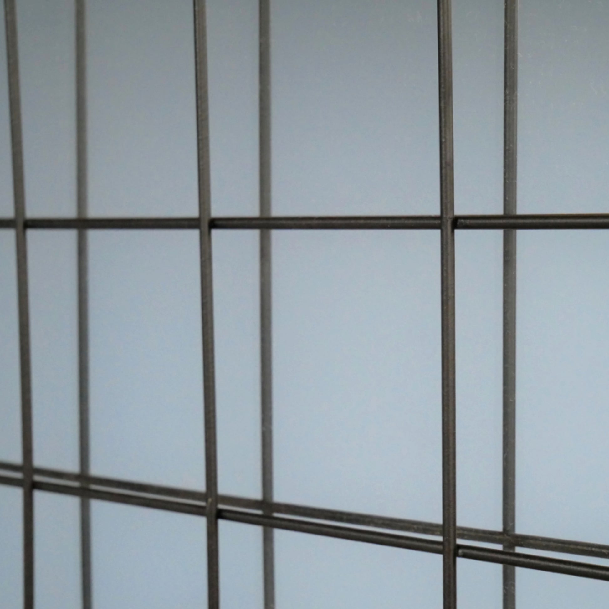 Metal grid against a light blue background