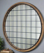 Round window with black grid on a brick wall