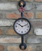 Decorative wall clock with industrial design on a brick wall