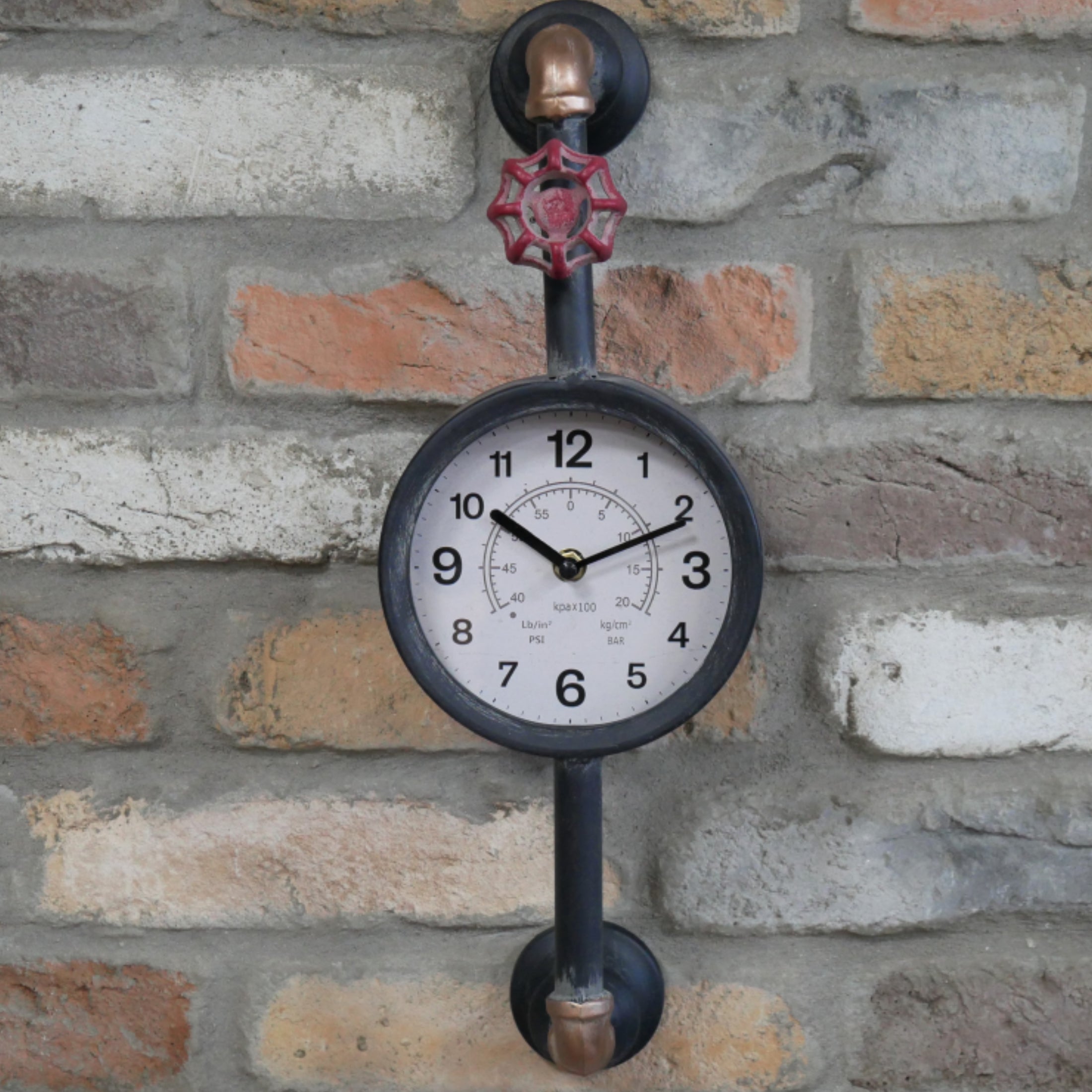 Decorative wall clock with industrial design on a brick wall