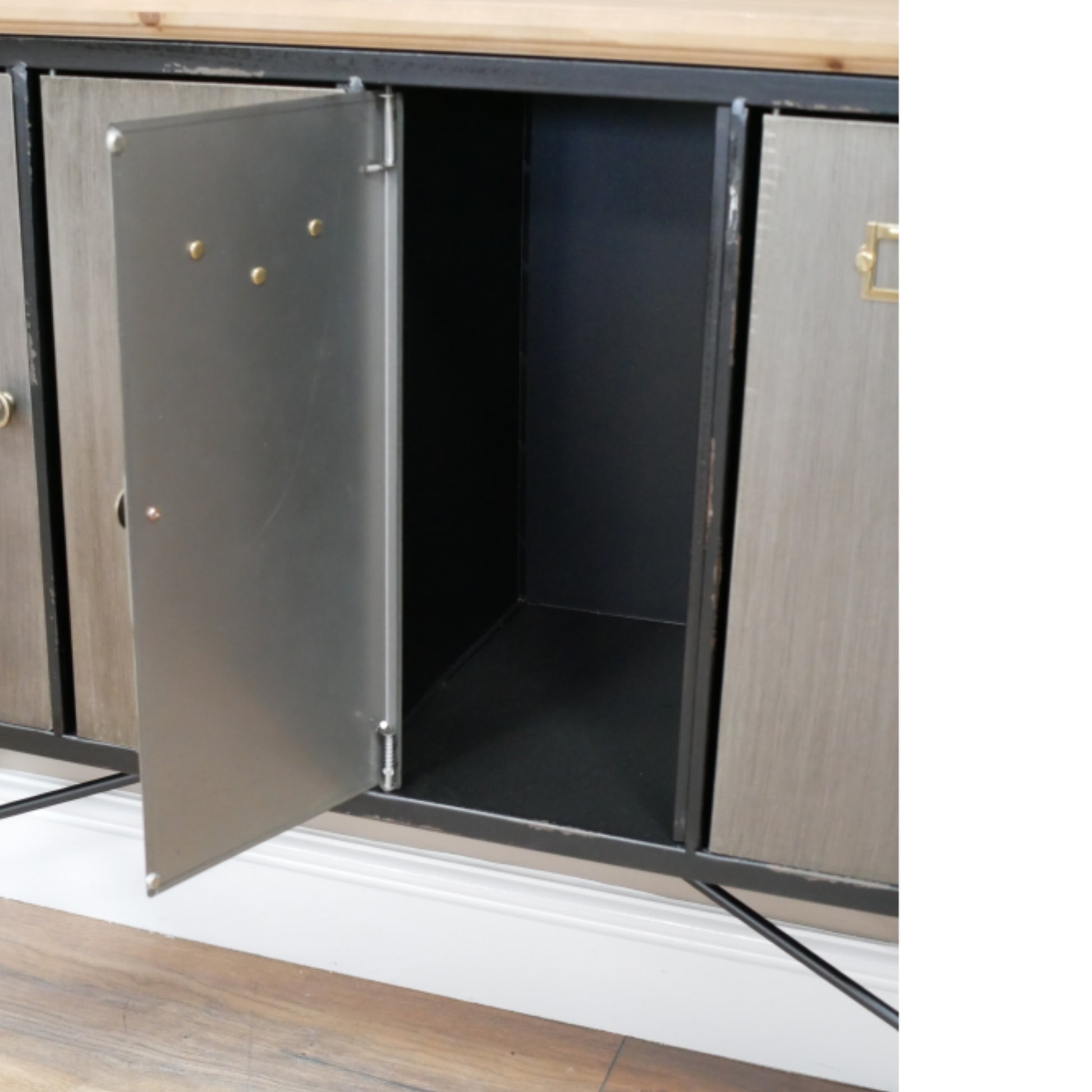 Cabinet with open doors revealing a black interior.