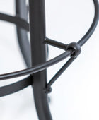Close-up of a black metal stand on a white background