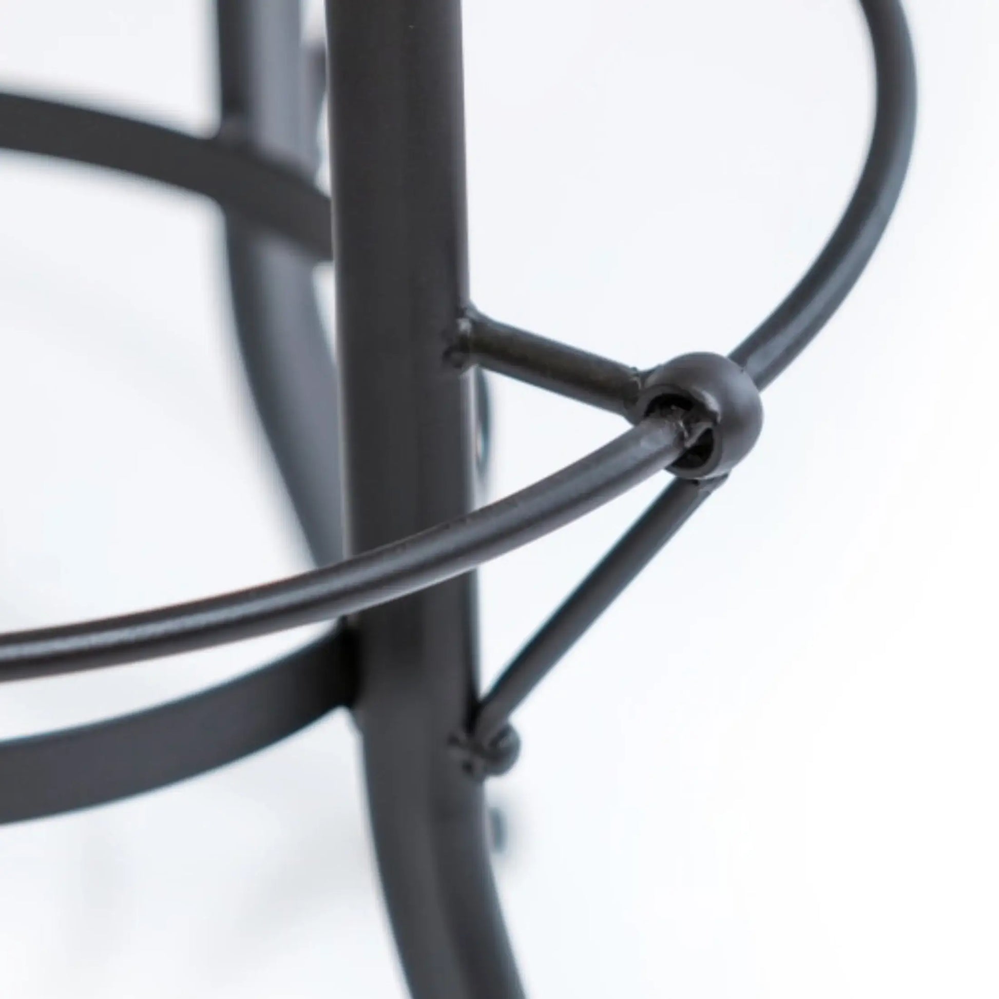 Close-up of a black metal stand on a white background