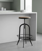 Bar stool with wooden seat and metal frame in a modern kitchen setting