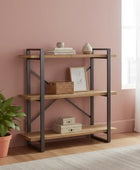 Wooden shelf with decorative items against a pink wall