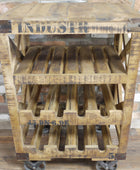 A rustic three-tier wooden rolling cart made from a pallet, featuring a slatted top, wine bottle holders on the middle and bottom tiers, and castor wheels. The wood has a weathered brown finish with black stenciled text.