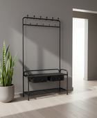 Black metal coat rack with hooks and storage drawers next to a potted plant in a room with a bright light source.
