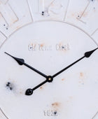 Close-up of a clock face with 'Old Town Clock' branding on a white background