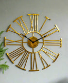 Gold wall clock with Roman numeral design on a white background