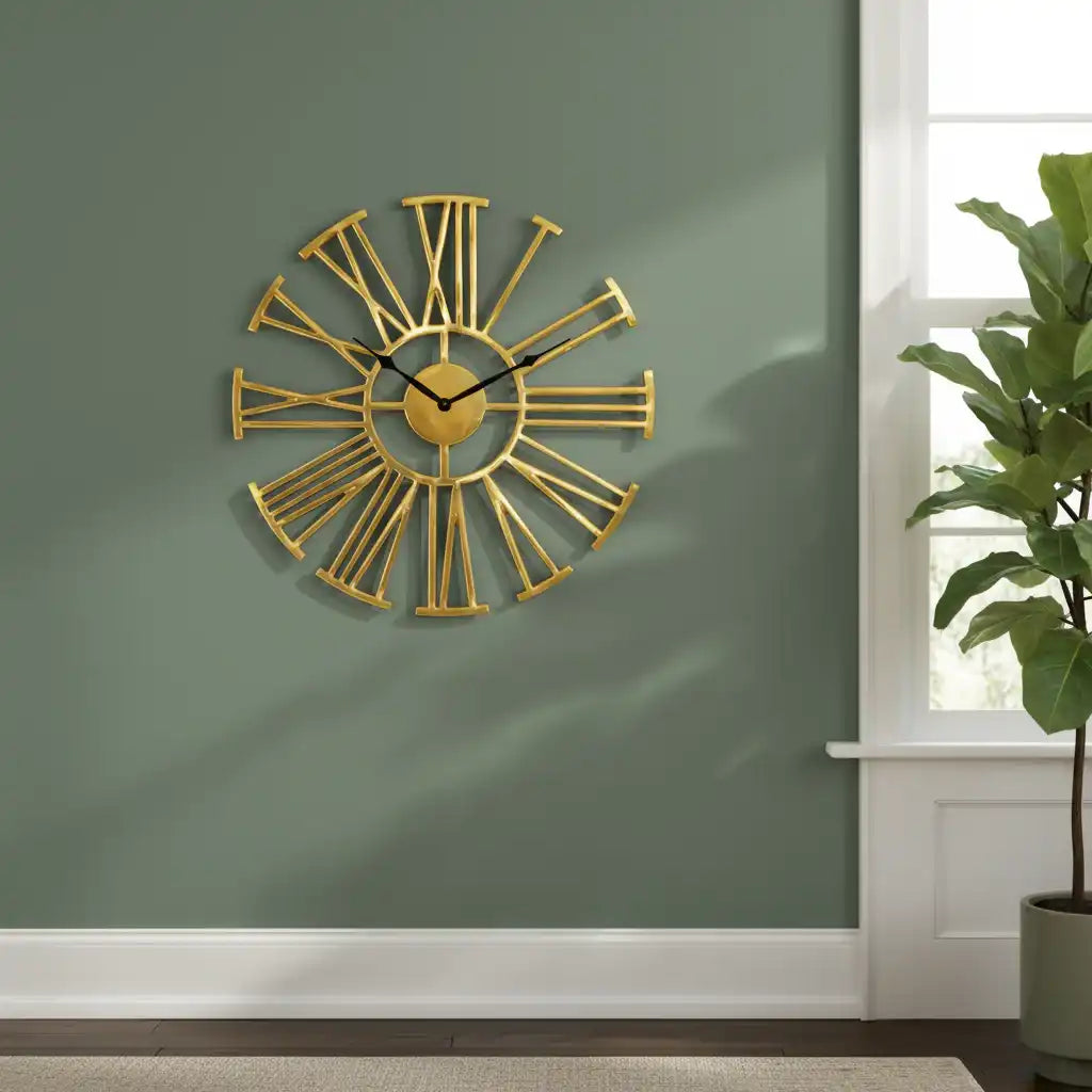 Gold wall clock on a green wall with a plant in the corner