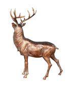 Bronze deer statue on a wooden surface with a gray background