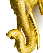 Gold elephant sculpture on a white background