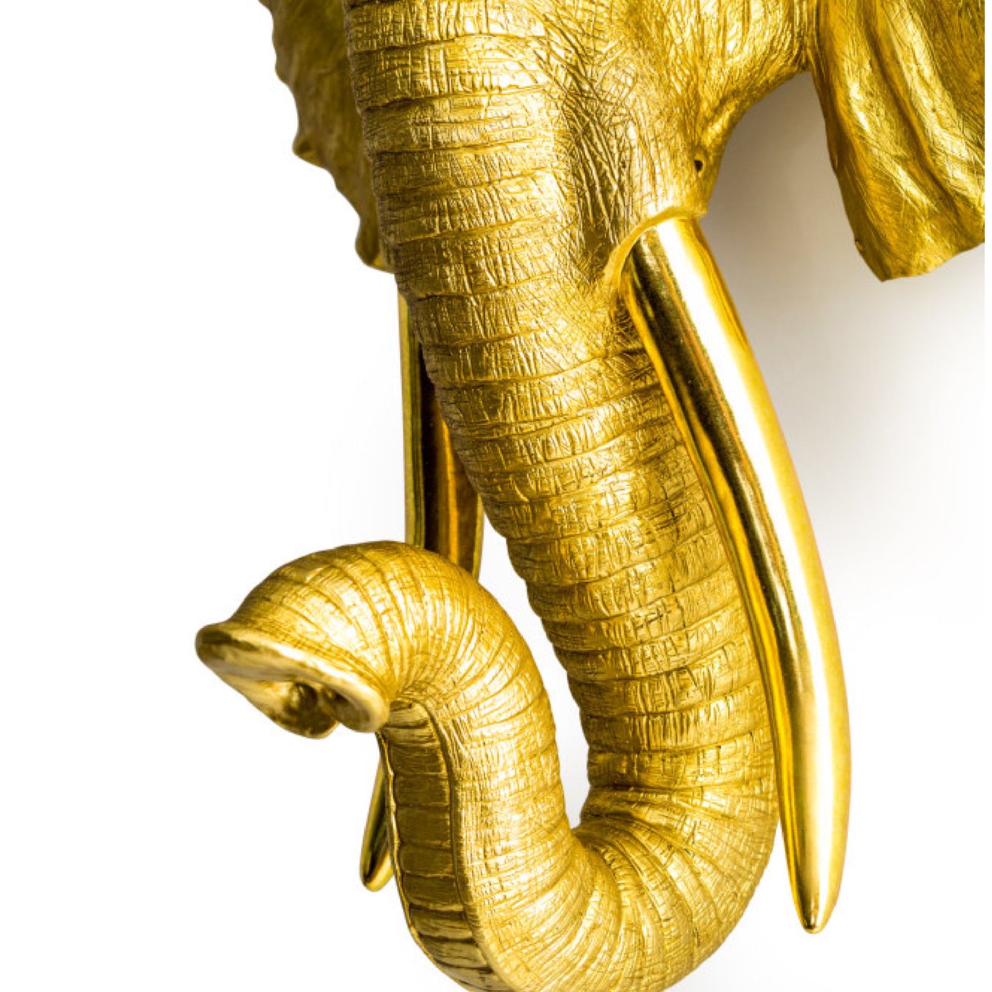 Gold elephant sculpture on a white background