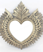 Decorative heart-shaped frame with leaf-like designs on a white background