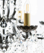 Close-up of a chandelier with a lit LED bulb inside, blurred background