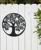 Black metal tree of life wall art on a white background