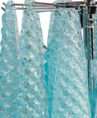 Close-up of a turquoise crystal shower curtain with a chrome rod.