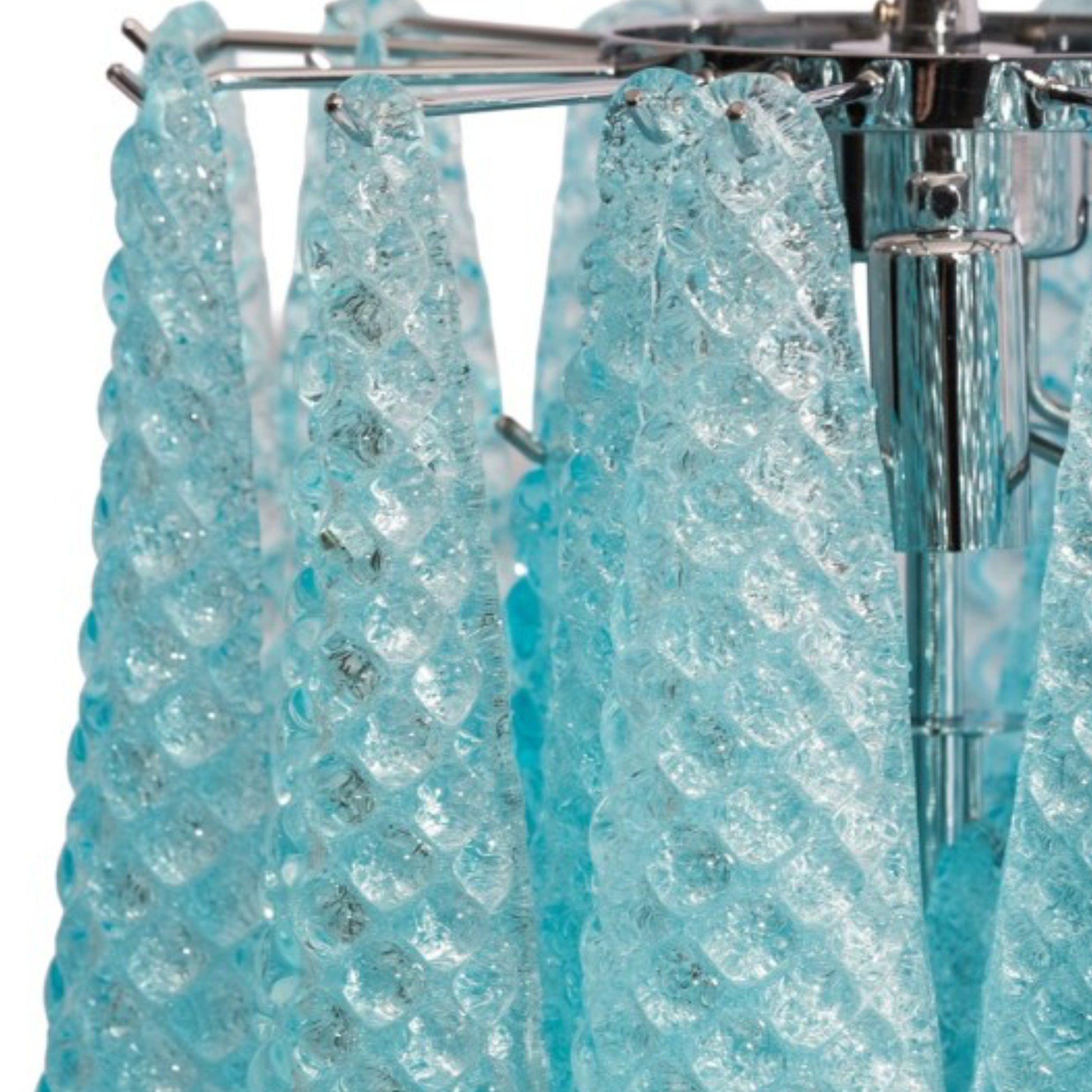 Close-up of a turquoise crystal shower curtain with a chrome rod.