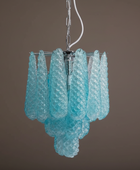 Turquoise glass chandelier against a brown background