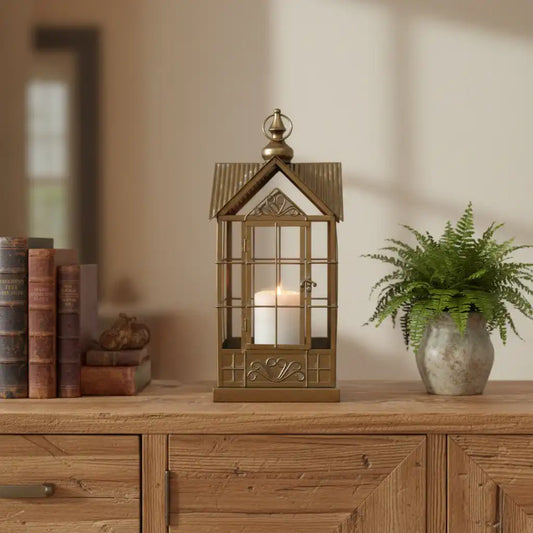 Decorative lantern with a candle inside on a wooden surface.