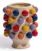 A beige ceramic vase decorated with multiple glossy, colorful spherical protrusions in red, yellow, orange, purple, and blue, set against a plain white background.