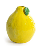 Yellow ceramic lemon-shaped vase with a green leaf on a white background