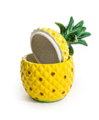 Pineapple-shaped container with a lid on a white background