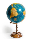 Vintage-style globe on a stand with a white background