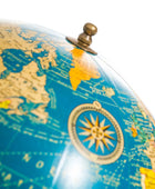 Close-up of a vintage-style globe with detailed world map and compass.