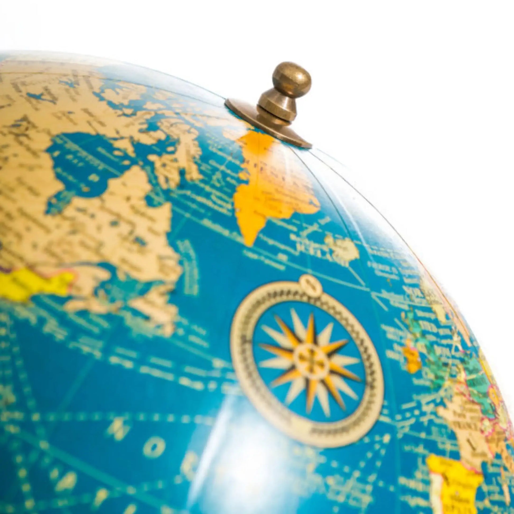 Close-up of a vintage-style globe with detailed world map and compass.