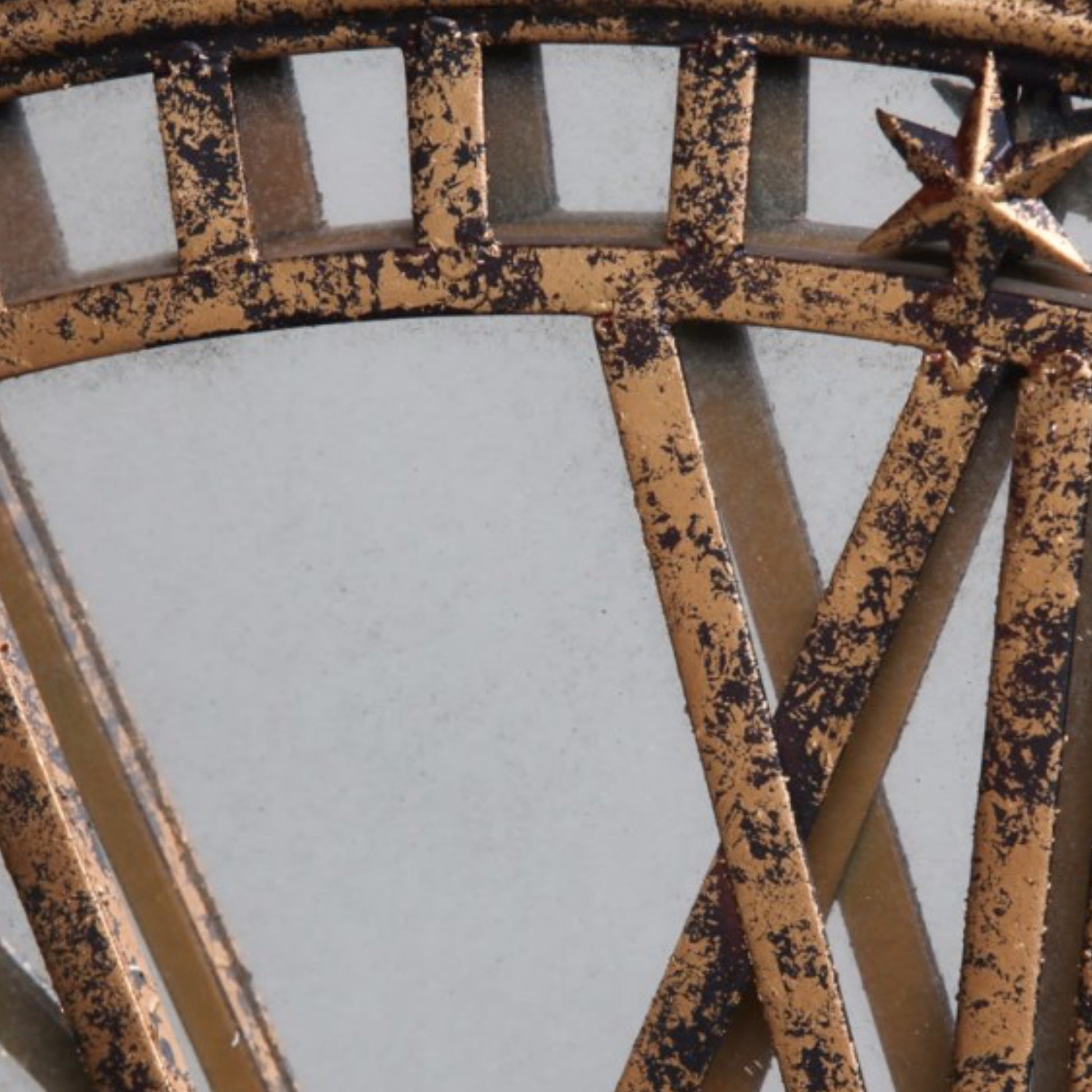 Close-up of a rusted metal gate with star design on a light gray background